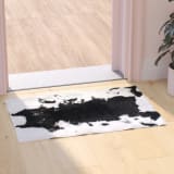 Barstow Collection 2' x 3' Black Faux Cowhide Print Olefin Area Rug with Jute Backing for Living Room, Bedroom, Entryway