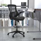 Mid-Back Black Mesh Ergonomic Drafting Chair with LeatherSoft Seat, Adjustable Foot Ring and Flip-Up Arms